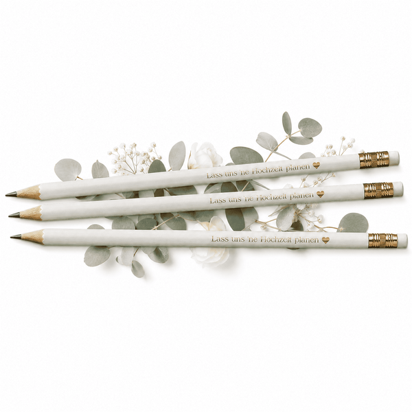 Drei weiße Bleistifte mit goldenem Radiergummikopf und dem Text "Lass uns 'ne Hochzeit planen" von Mein kleines Hochzeitsbüro liegen auf Eukalyptusblättern - das perfekte Bleistift-Set für deine Hochzeitsplanung.
